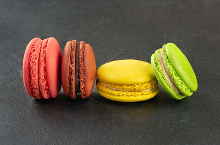 Delicious four colored macaroons on a dark backgroundの写真素材