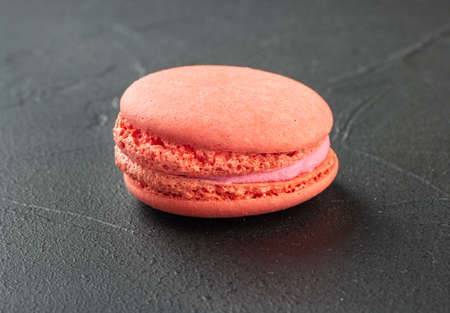 Sweet raspberry macaroon on dark backgroundの写真素材