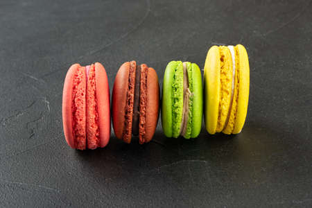 Four multicolored macaroons on concrete backgroundの写真素材