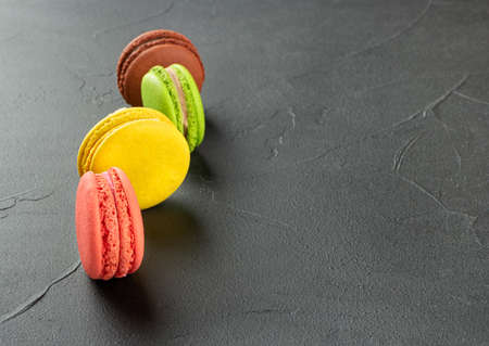 Sweet four colored macaroons on dark backgroundの写真素材