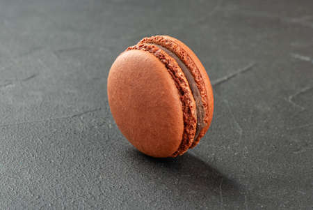 Delicious chocolate macaroon on concrete backgroundの写真素材