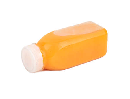 Fresh carrot juice in plastic bottle isolated on white backgroundの写真素材