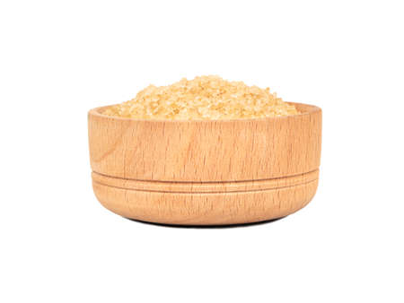 Wooden bowl with brown sugar isolated on white backgroundの写真素材