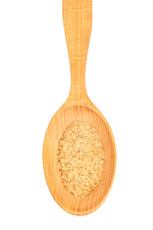Brown sugar in a wooden spoon isolated on a white background, top viewの写真素材