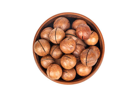 Macadamia nut in a ceramic bowl on a white background, top viewの写真素材