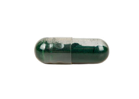 Transparent capsule with medicinal green grass isolated on a white backgroundの写真素材