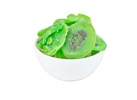 Dry kiwi slices in a ceramic bowl isolated on white backgroundの写真素材