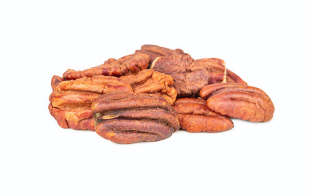 Small pile of dry pecan halves without shell isolated on white background.の写真素材
