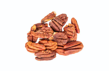 Small pile of dry pecan halves without shell isolated on white background.の写真素材