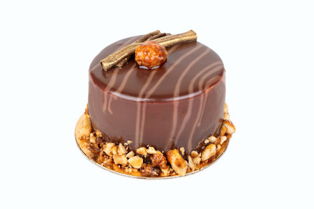 Chocolate cake with salty and sweet caramel inside, doused with icing with nuts. Very tender and tasty dessert.の写真素材