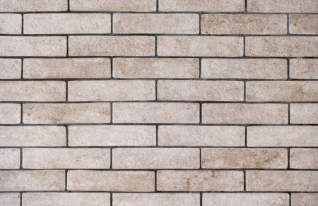 Background of a wall of gray and dirty bricks close-up.