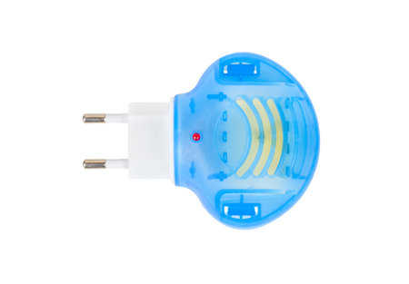 Blue fumigator for repelling mosquitoes in a socket with an euro plug isolated on a white background. top viewの写真素材