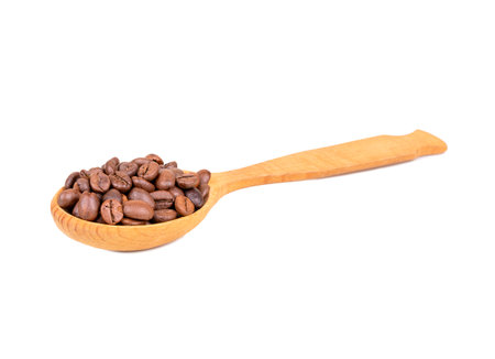 Coffee beans in wooden spoon isolated on white backgroundの写真素材