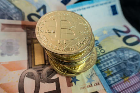 coins of bitcoin on dollar notes