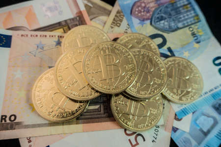 coins of bitcoin on dollar notesの写真素材