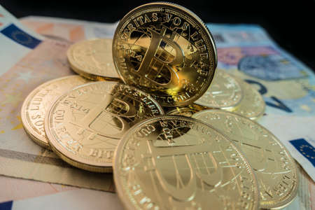 coins of bitcoin on dollar notesの写真素材
