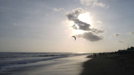 Enjoy sunset moment while playing at the beachの写真素材