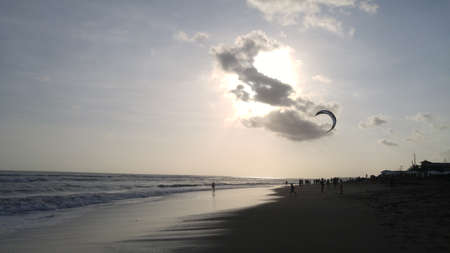Enjoy sunset moment while playing at the beachの写真素材