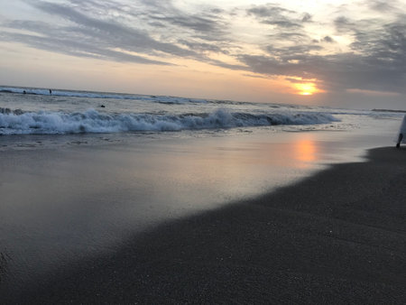 Enjoy sunset moment while playing at the beachの写真素材
