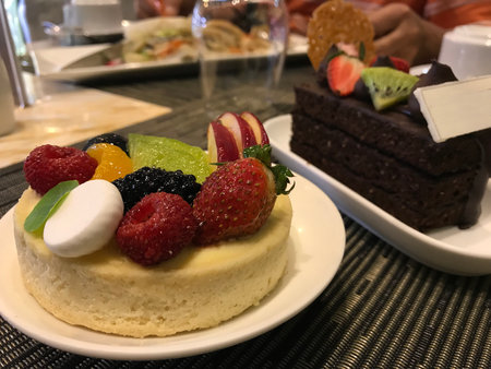 Close up of a delicious fruit cake on a white plate in a restaurantの写真素材