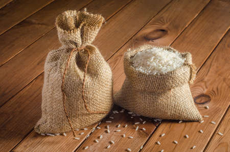 Rice in bags on a wooden tableの写真素材