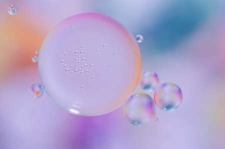 colored oil droplets on the water surfaceの写真素材