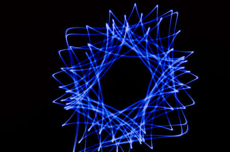 Light spiral and blue lines on a black background