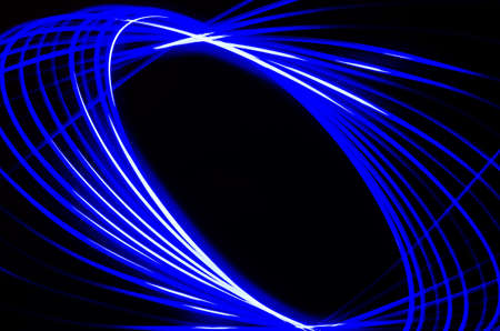 Light spiral and blue lines on a black backgroundの写真素材