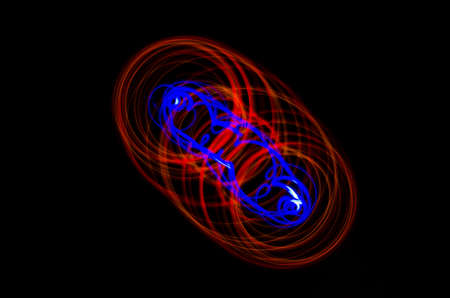 Light spiral, red and blue lines on a black backgroundの写真素材