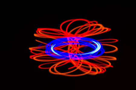 Light spiral, red and blue lines on a black backgroundの写真素材