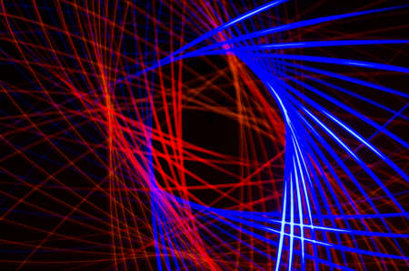 Light spiral, red and blue lines on a black backgroundの写真素材