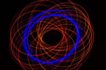 Light spiral, red and blue lines on a black backgroundの写真素材
