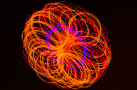 Light spiral, red and blue lines on a black backgroundの写真素材