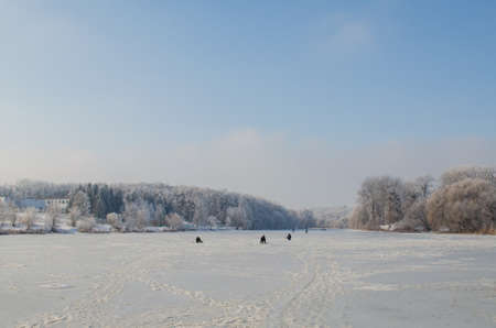 Winter fishing on frozen lake.の写真素材