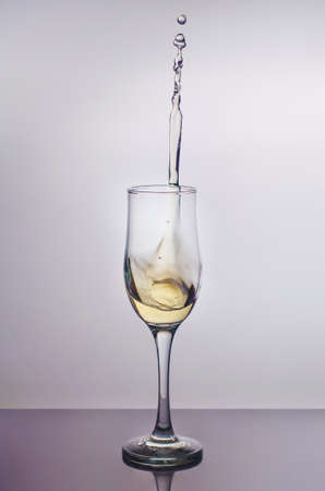 Splash in a glass of champagne.の写真素材