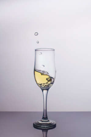 Splash in a glass of champagne.の写真素材