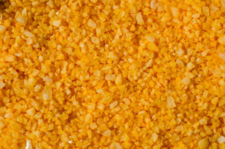 Yellow sea salt close-up background.