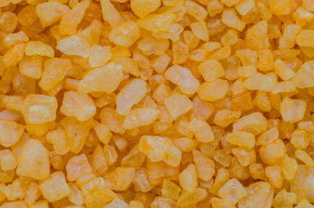 Yellow sea salt close-up background.