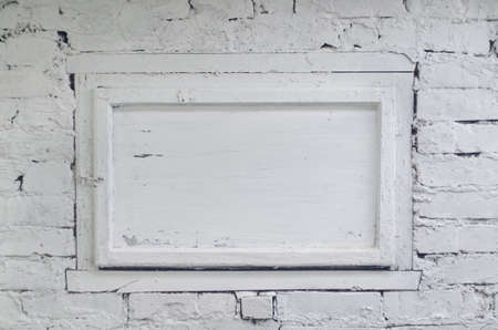 White brick wall with a window.