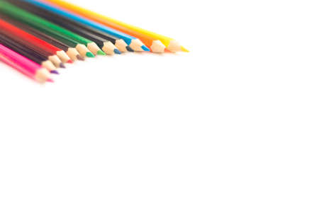 Colored pencils on a white background closeup.
