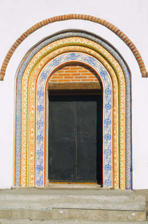 Iron door in the arch painted ornament.の写真素材