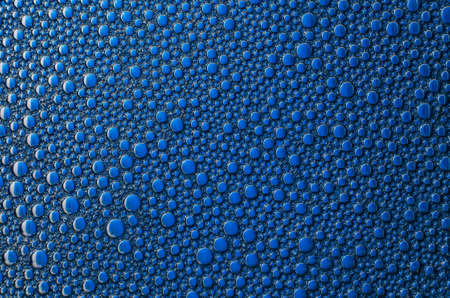 Foam bubbles on a blue background textureの写真素材