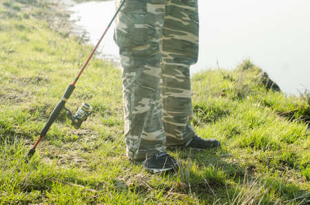 Fisherman on a river with a spinning rod.