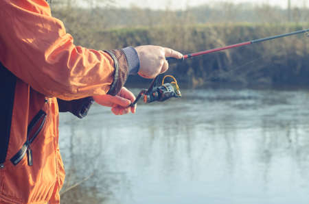 Hands of the fisherman with spinningの写真素材