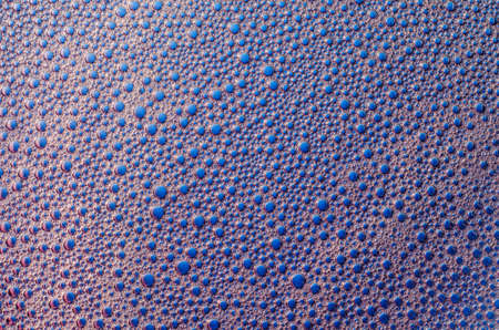 Foam bubbles on a blue background texture.