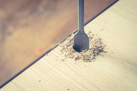Drilling holes in a wooden block.の写真素材