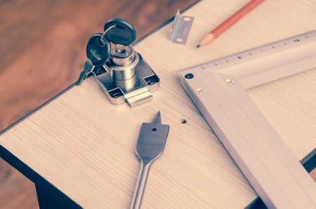 Carpenter's pencil, square, drill feather and mortise lock.の写真素材