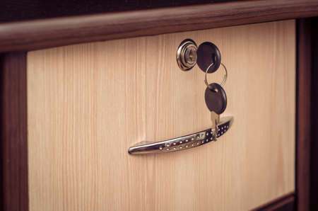 Bedside table with lockable drawer and key.の写真素材