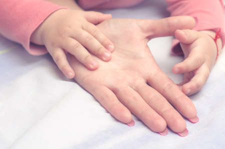The hand of the child in the mother's hand.の写真素材
