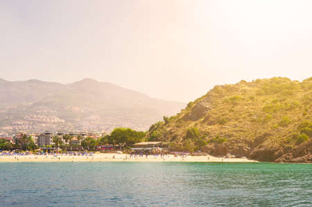 View from the sea to the city and the beach in sunlight. Toned.の写真素材